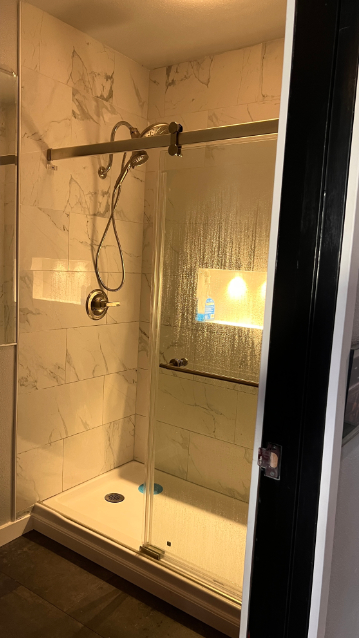 Private marble-tiled premium shower at Flex Fitness OC
